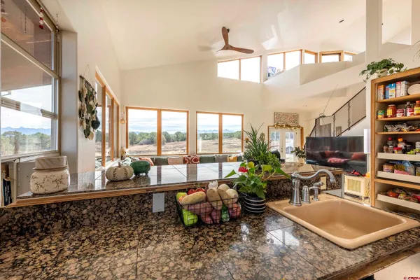 a very nice looking living room with a large window and a couch