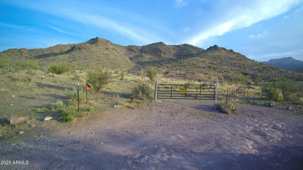 a view of a field with mountains in the background