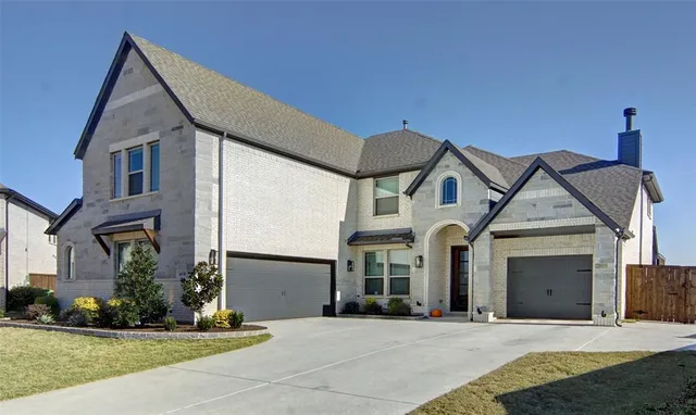 a view of a white house with a yard and plants