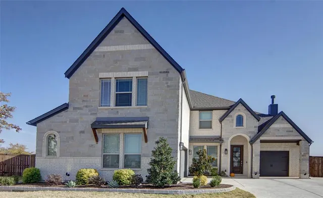 a view of a brick house with potted plants