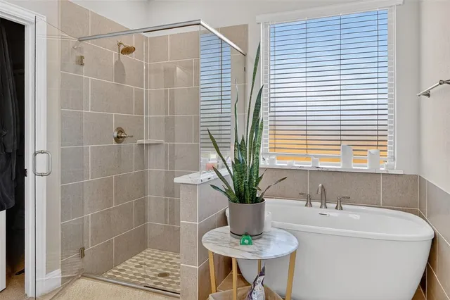 a bathroom with a sink and a potted plant