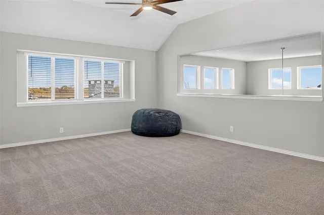 an empty room with windows and cabinet