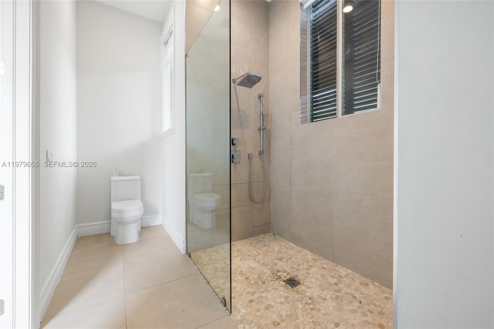 11950 Southwest 43rd Street Miami, FL 33175 - Photo 42 of 78 a bathroom with a toilet and a shower