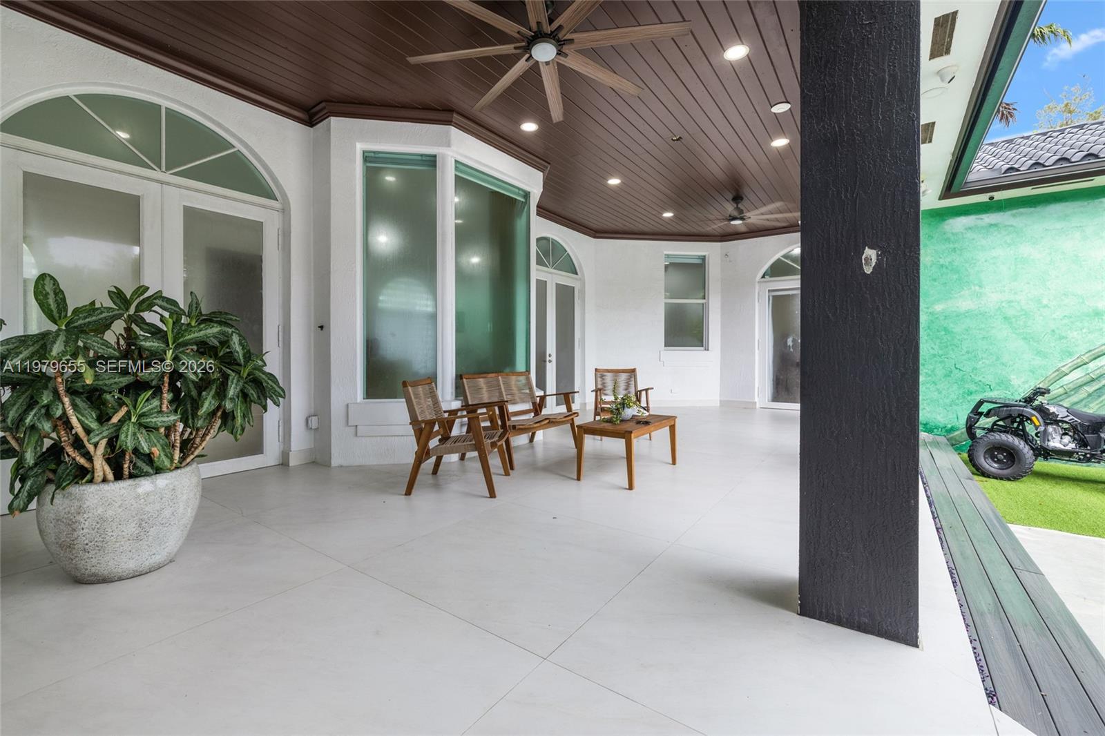 11950 Southwest 43rd Street Miami, FL 33175 - Photo 45 of 78 a view of a porch with chairs and potted plants