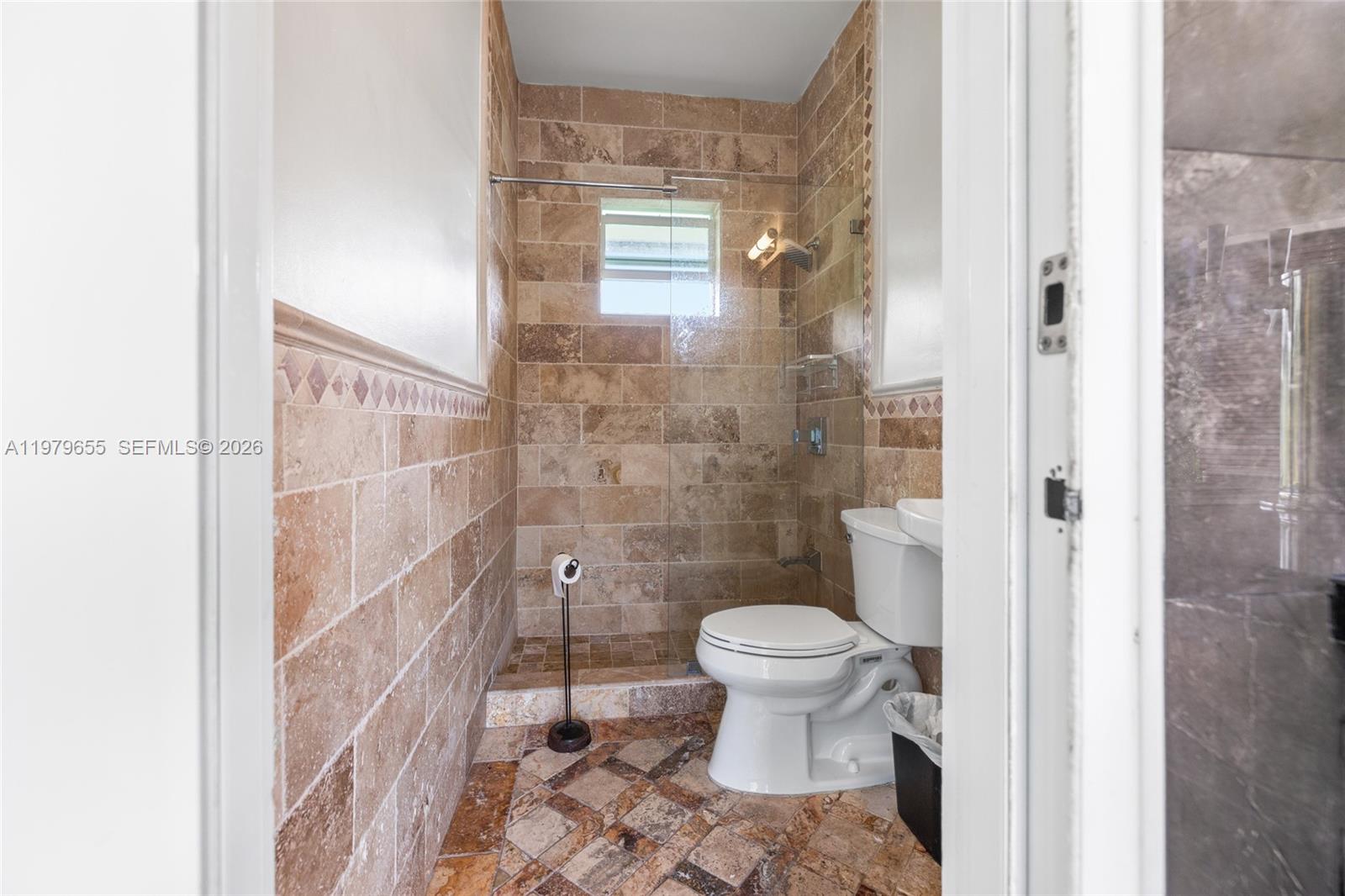 11950 Southwest 43rd Street Miami, FL 33175 - Photo 58 of 78 a bathroom with a toilet and a shower