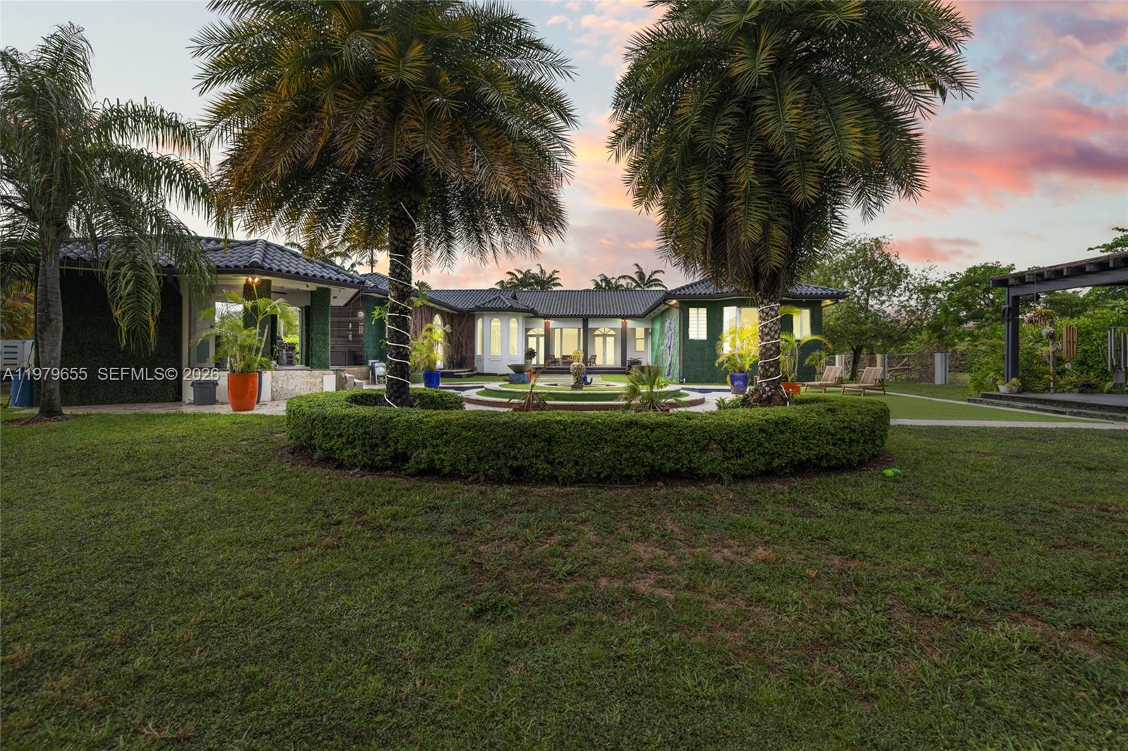 11950 Southwest 43rd Street Miami, FL 33175 - Photo 62 of 78 a front view of a house with a garden and trees