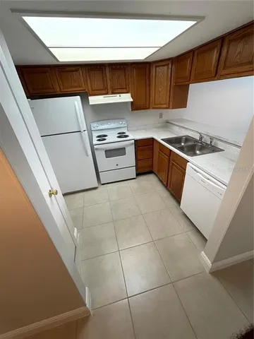 a kitchen with a stove a sink and a refrigerator