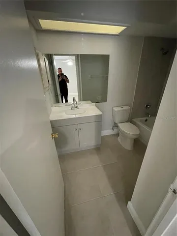 a bathroom with a toilet a sink and bathtub