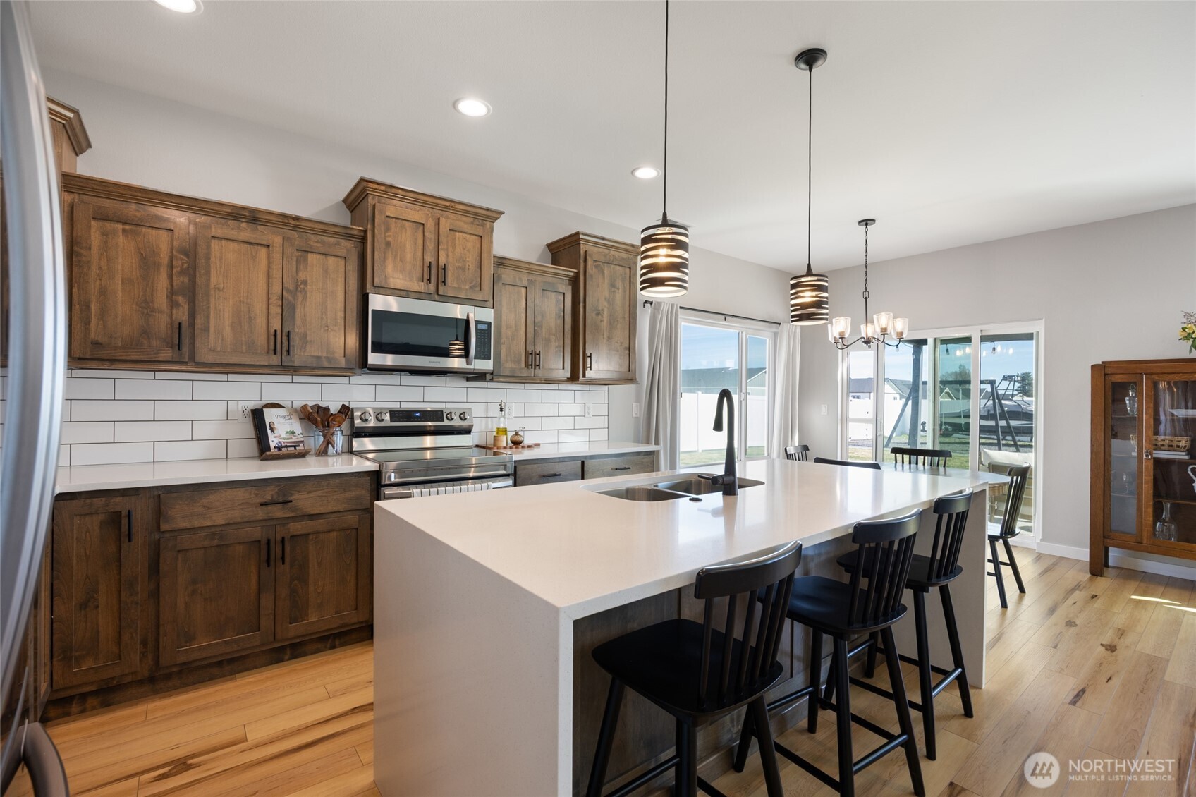 2376 Chelan Street Ephrata, WA 98823 - Photo 12 of 40 a kitchen with stainless steel appliances kitchen island granite countertop a stove a sink a oven a dining table and chairs