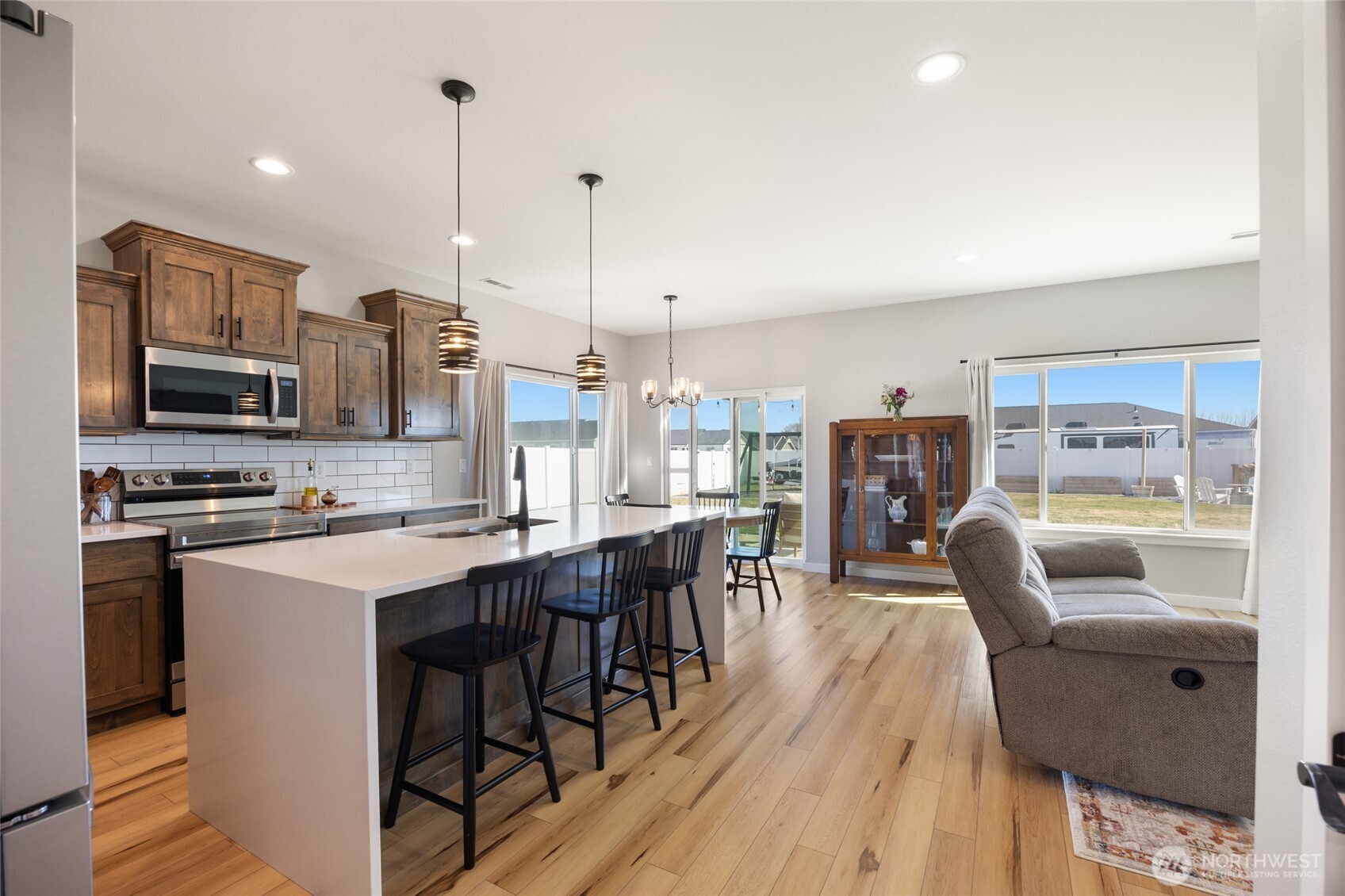 2376 Chelan Street Ephrata, WA 98823 - Photo 6 of 40 a view of kitchen with stainless steel appliances granite countertop a stove a sink a dining table and chairs with wooden floor