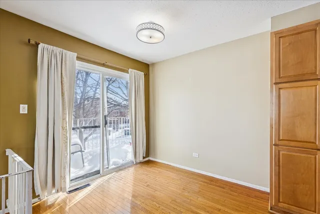 a view of a room with wooden floor and entryway