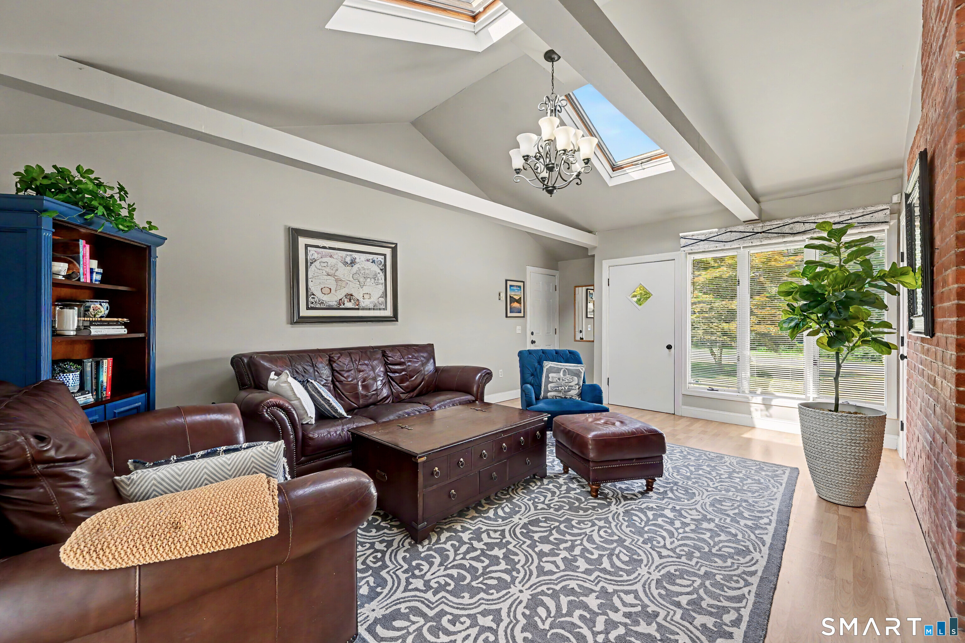 524 Ferry Road Orange, CT 06477 - Photo 16 of 40 a living room with furniture a chandelier and a rug