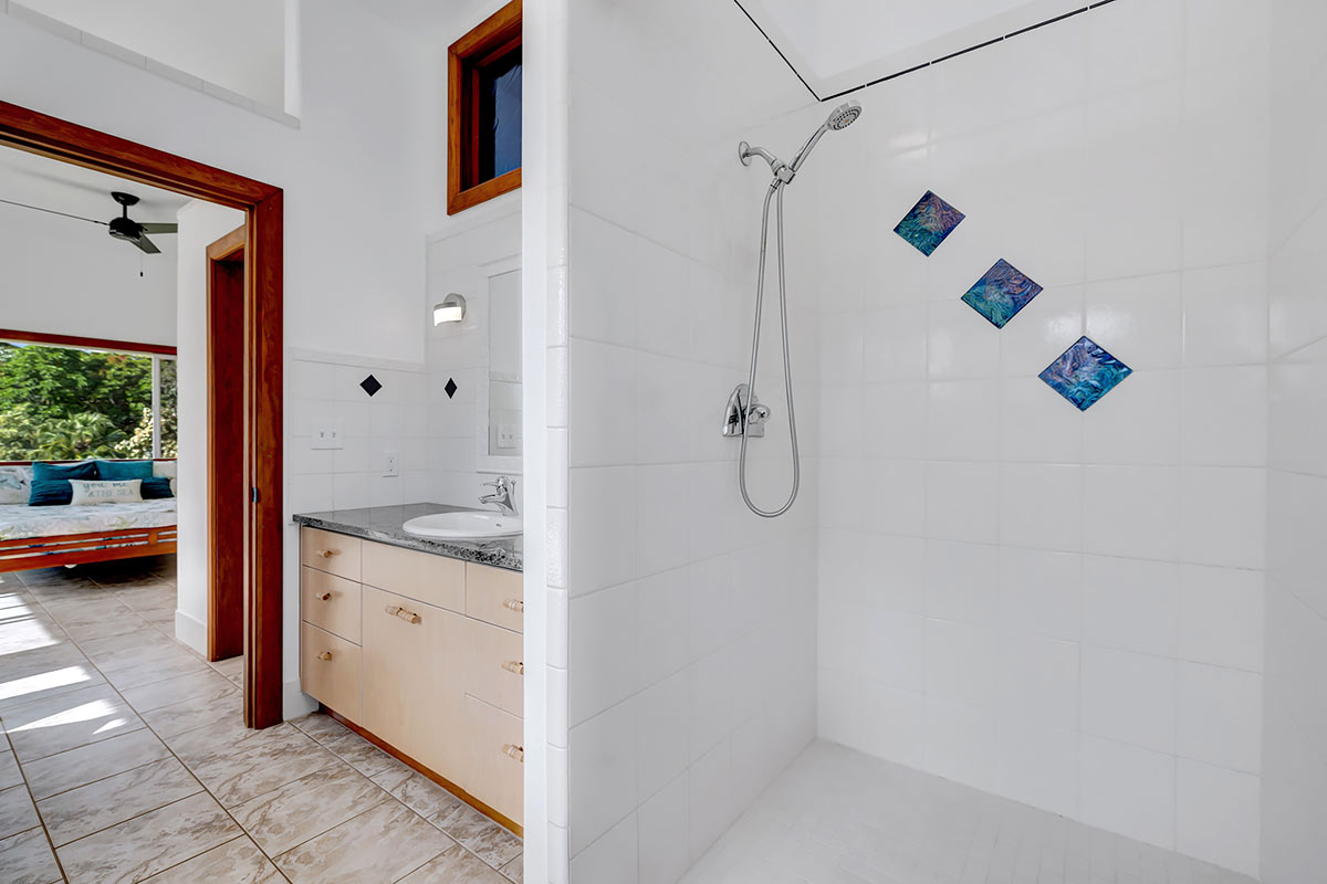 13-5725 Kalapana Kapoho Beach Road Pahoa, HI 96778 - Photo 14 of 25 a bathroom with a granite countertop sink a mirror and shower