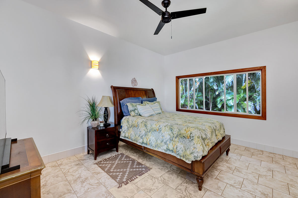 13-5725 Kalapana Kapoho Beach Road Pahoa, HI 96778 - Photo 15 of 25 a bedroom with a bed window and potted plant on the dresser