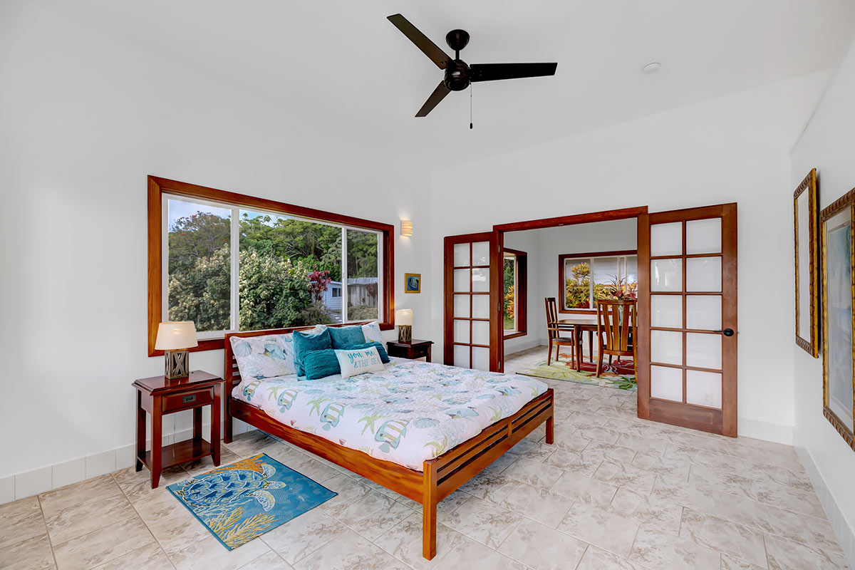 13-5725 Kalapana Kapoho Beach Road Pahoa, HI 96778 - Photo 18 of 25 a living room with furniture a rug and a large window