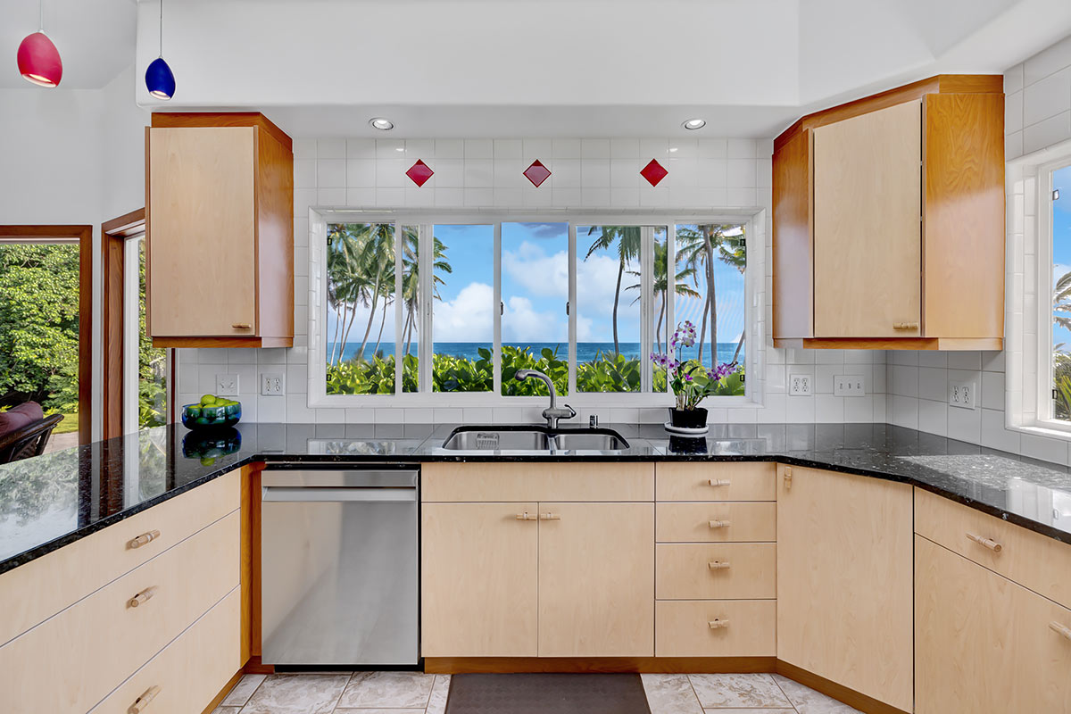 13-5725 Kalapana Kapoho Beach Road Pahoa, HI 96778 - Photo 10 of 25 a kitchen with stainless steel appliances white cabinets and wooden floor