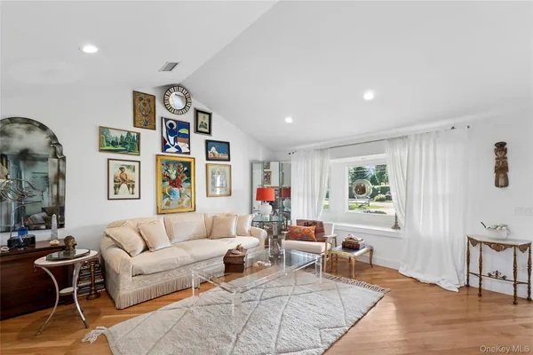 a living room with furniture and paintings on the wall