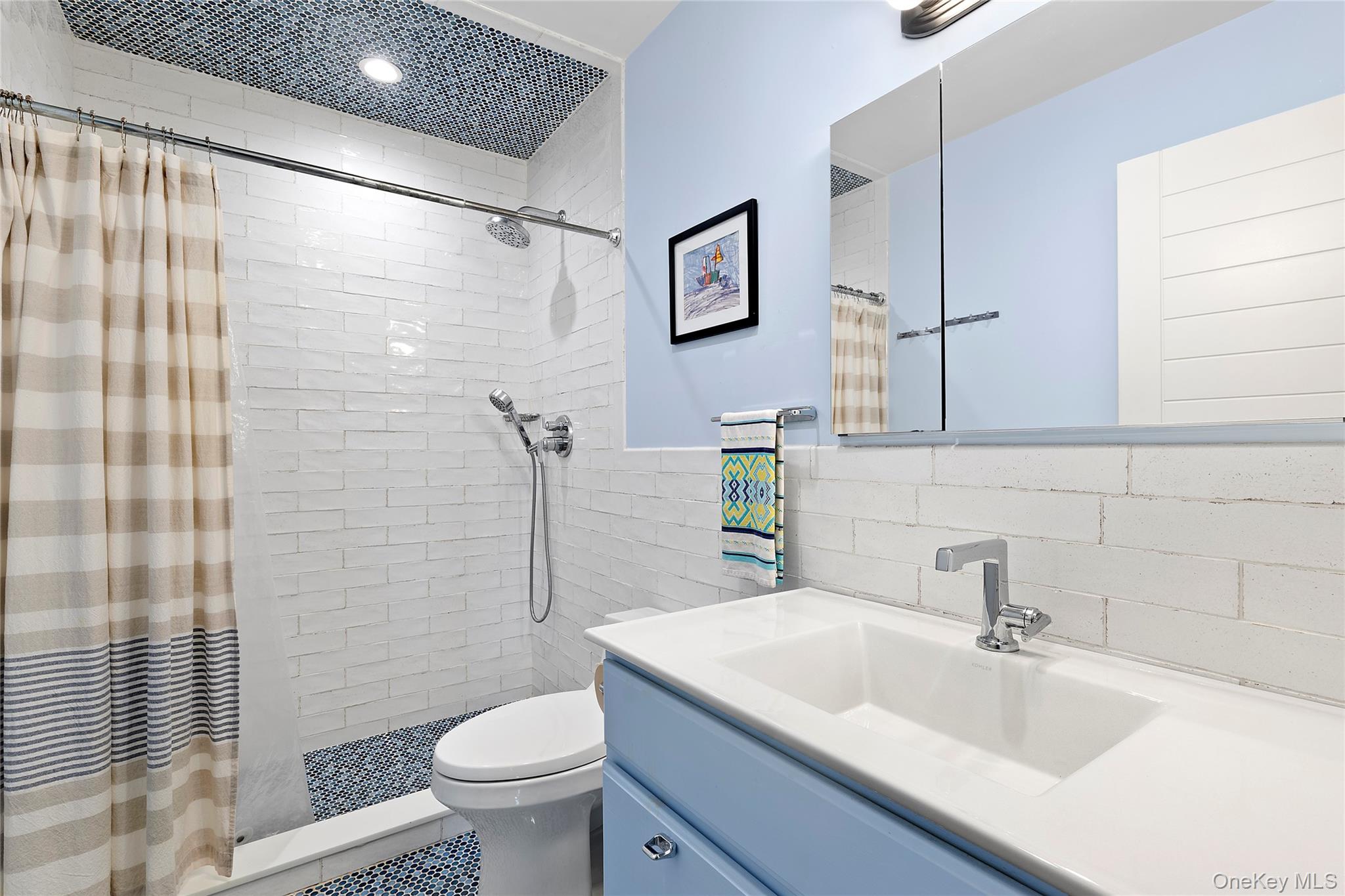 38 Liberty Street Westhampton Beach, NY 11978 - Photo 10 of 23 Full bathroom with vanity, tile walls, and a tile shower