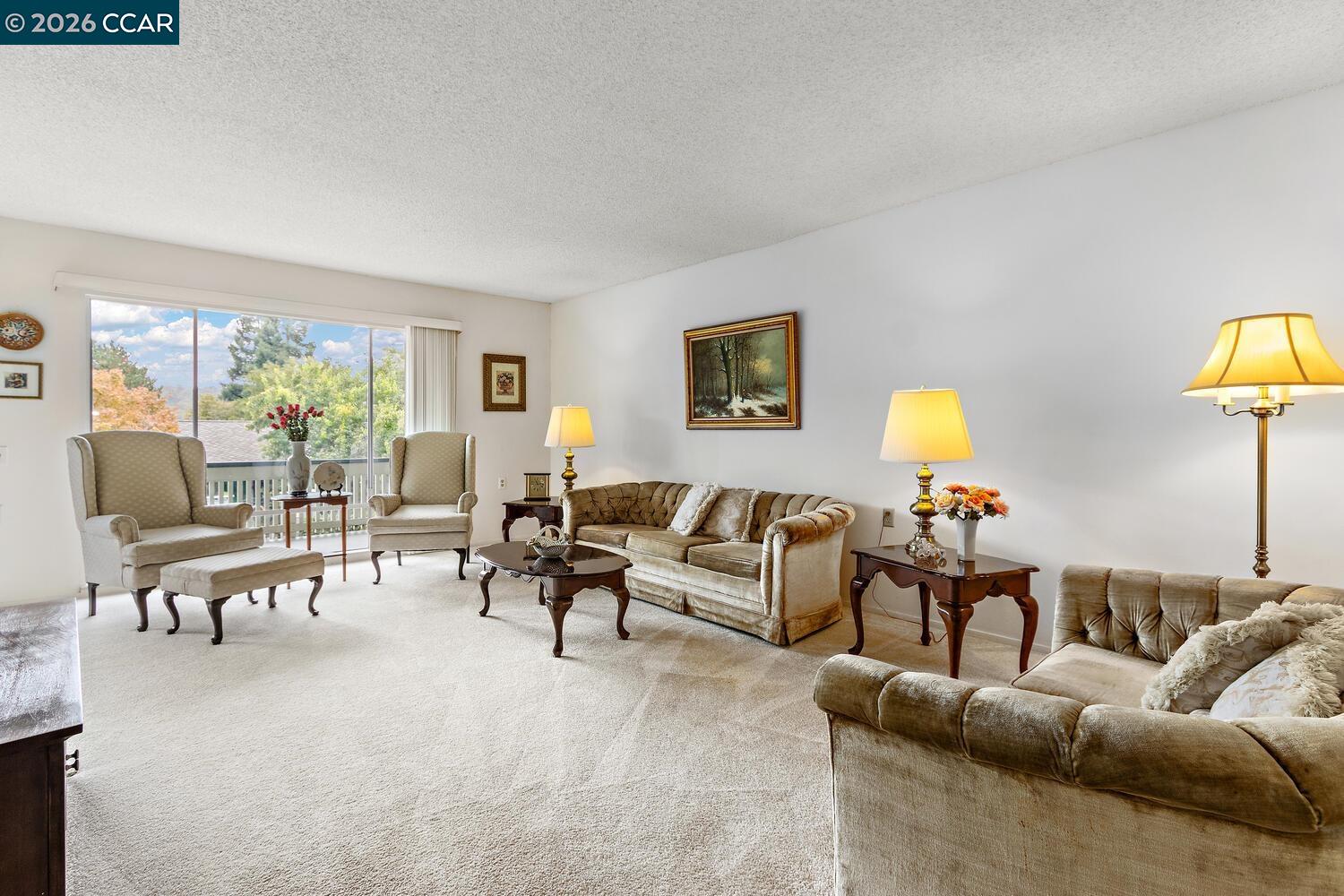 2709 Golden Rain Road, Unit 6 Walnut Creek, CA 94595 - Photo 3 of 46 a living room with furniture and a lamp