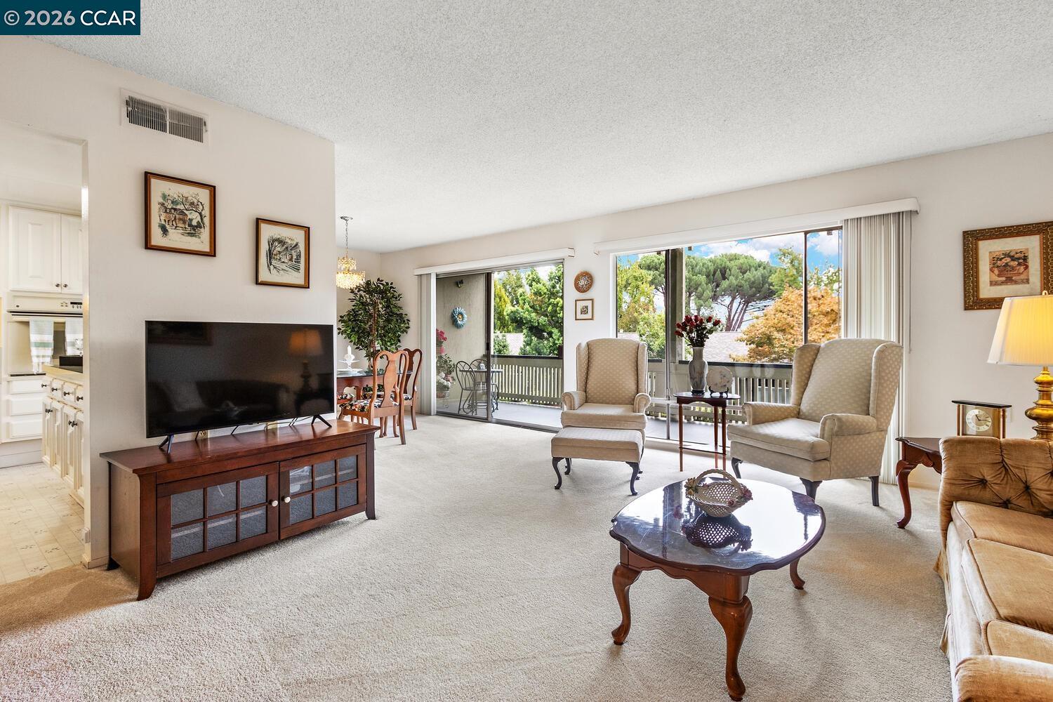 2709 Golden Rain Road, Unit 6 Walnut Creek, CA 94595 - Photo 4 of 46 a living room with furniture and a flat screen tv