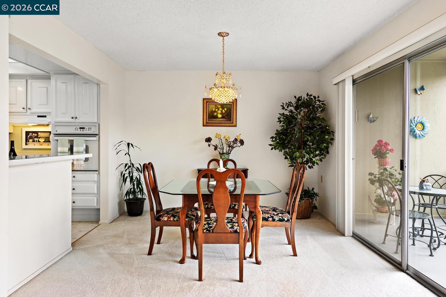 2709 Golden Rain Road, Unit 6 Walnut Creek, CA 94595 - Photo 8 of 46 a dining room with furniture potted plants and wooden floor