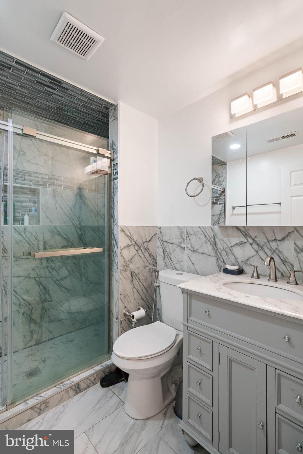 7616 Seabrook Lane Springfield, VA 22153 - Photo 29 of 37 Sleek modern bathroom with marble accents.