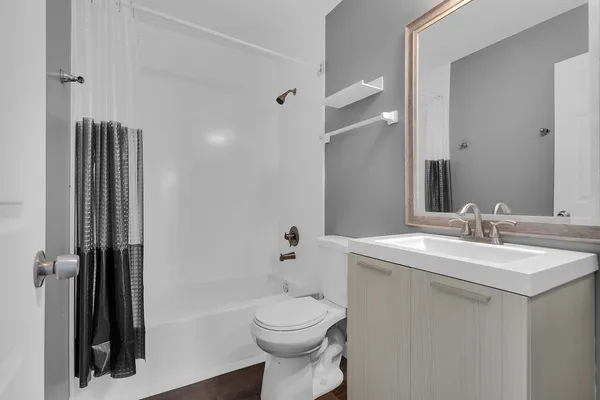 a bathroom with a sink toilet and shower