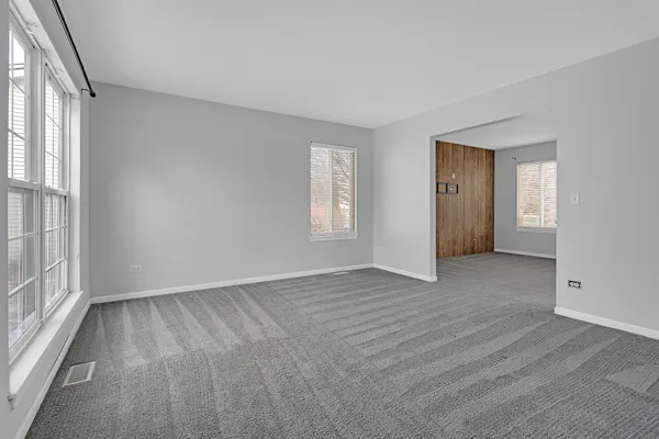 an empty room with windows and closet