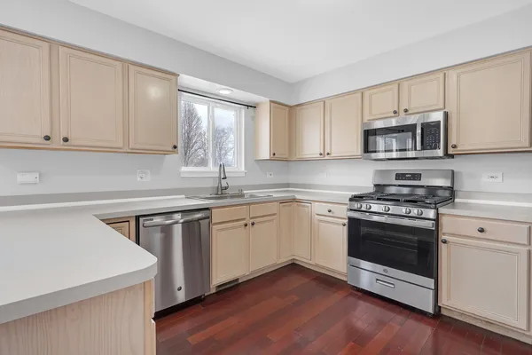 a kitchen with stainless steel appliances granite countertop a sink stove and cabinets