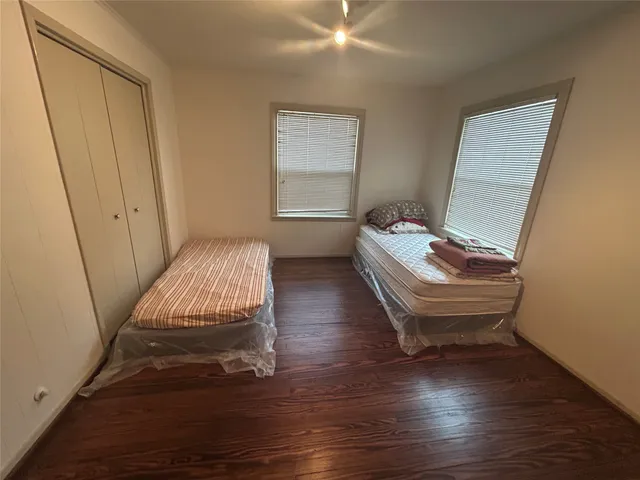 a room with wooden floor and stairs