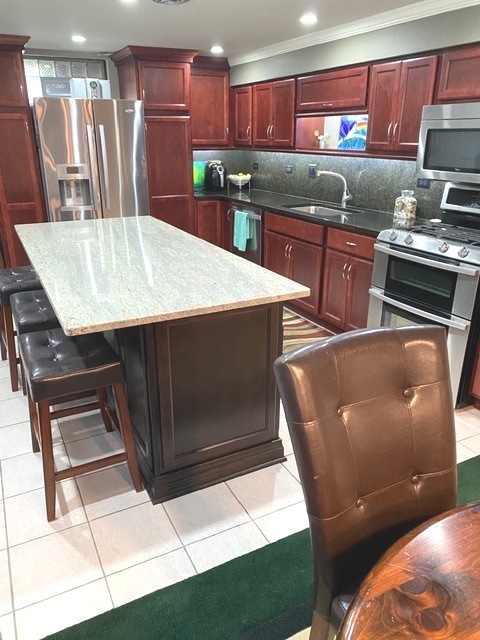 314 Ruth Avenue St. Charles, IL 60174 - Photo 19 of 36 a kitchen with stainless steel appliances wooden cabinets a stove a sink and a microwave