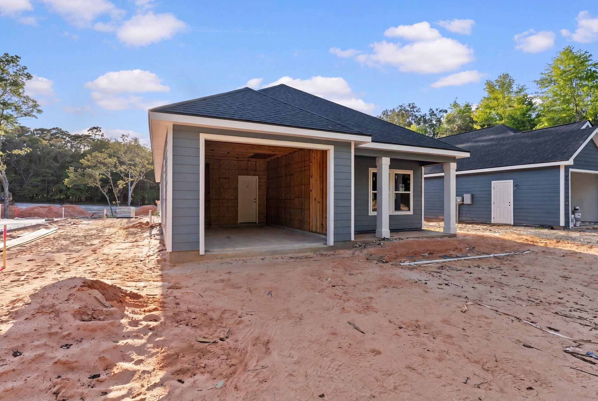 8657 Anniston Drive Elberta, AL 36530 - Photo 3 of 21 View of front of house featuring a shingled roof and a patio