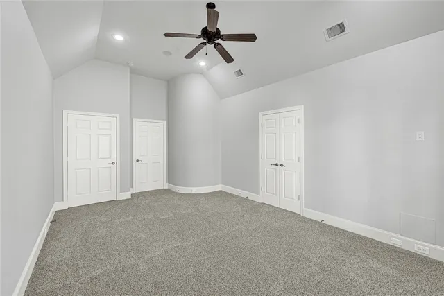 a bathroom with a granite countertop tub a double vanity sink and a window