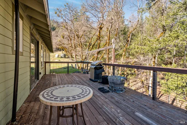 a view of wooden bench sitting in backyard of house
