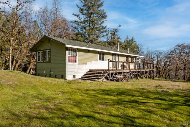 a open kitchen with stainless steel appliances granite countertop a stove a refrigerator a dining table and chairs with wooden floor