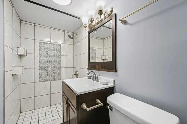 a bathroom with a sink toilet and shower