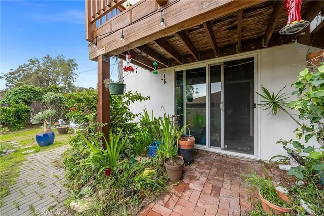 a view of a white house with a yard and plants