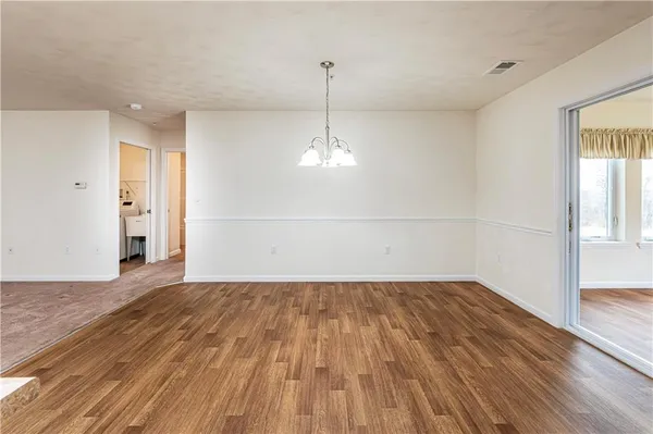 a kitchen with stainless steel appliances granite countertop a stove top oven a sink and dishwasher a refrigerator with wooden floor