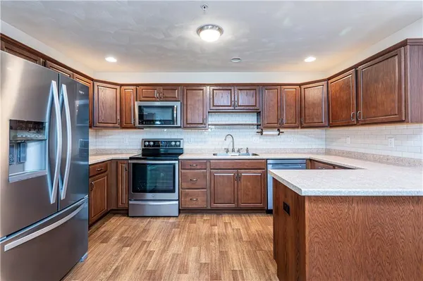 a kitchen with granite countertop stainless steel appliances and wooden cabinets