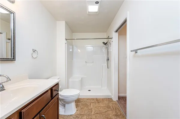 a en suite bathroom with a sink shower and a mirror
