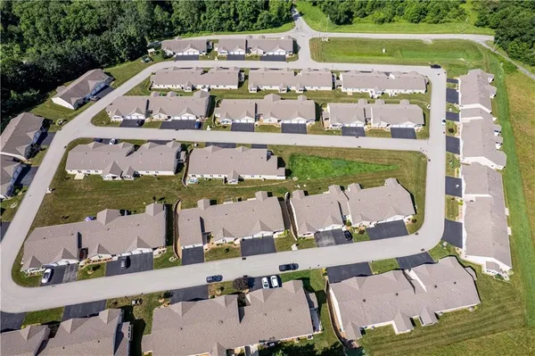 an aerial view of a house with a garden and lake view