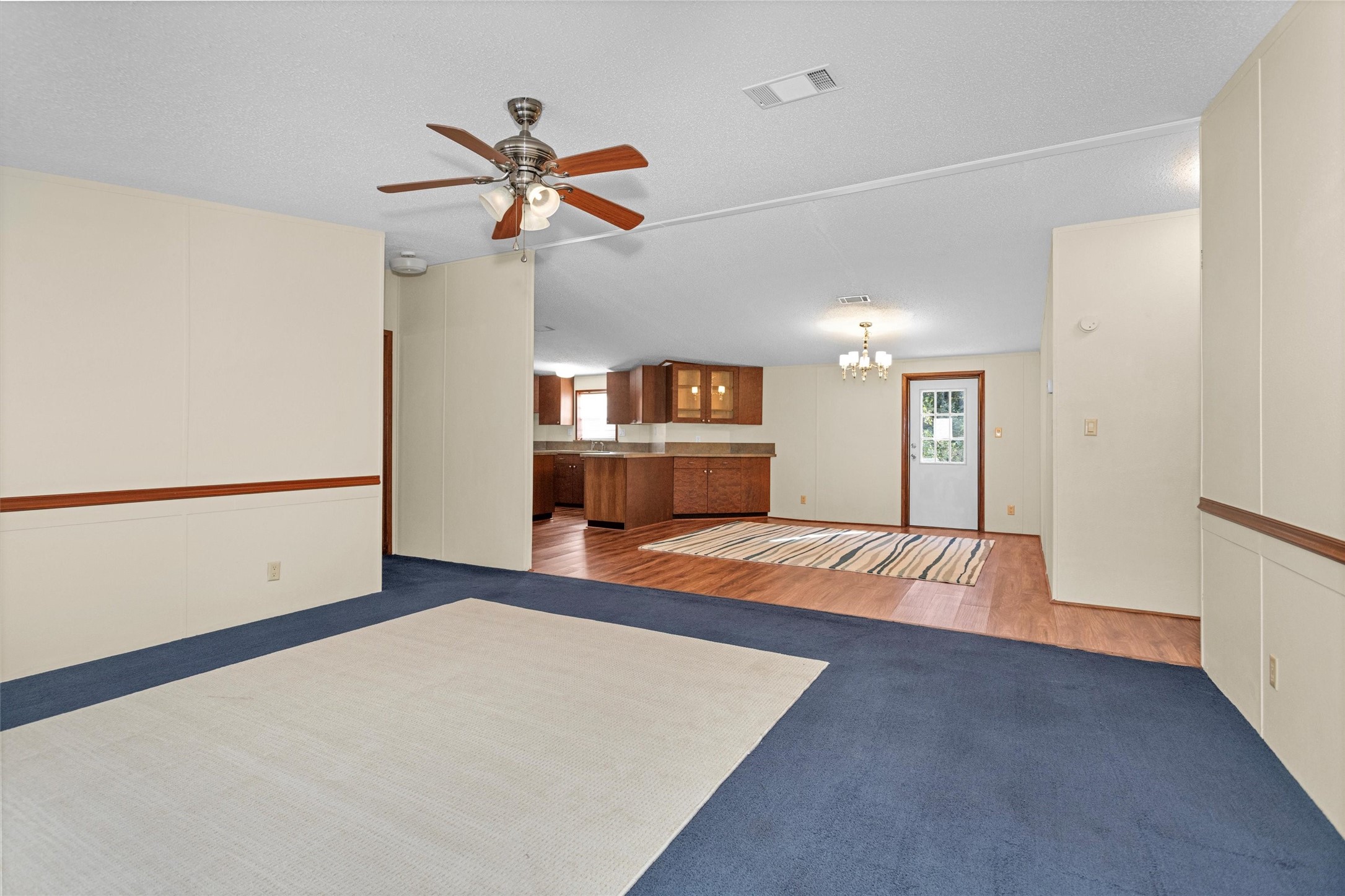11261 Rose Road Conroe, TX 77303 - Photo 7 of 30 a view of a room with wooden floor and ceiling fan