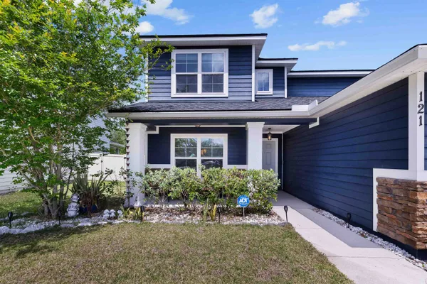 a front view of a house with a yard