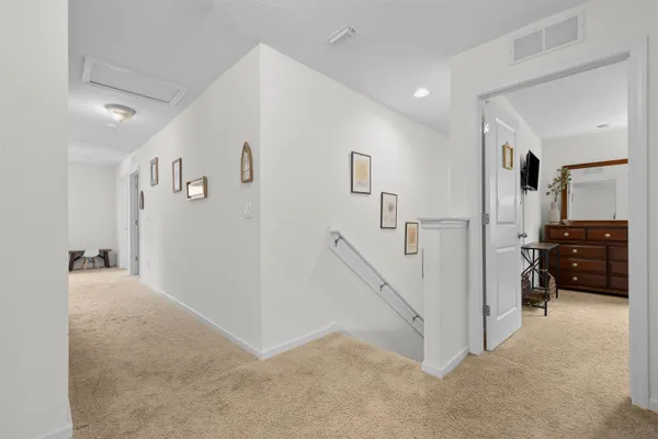 a view of hallway with livingroom and furniture