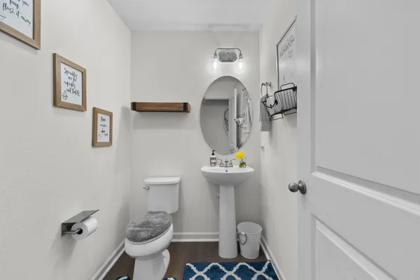 a bathroom with a sink toilet and mirror