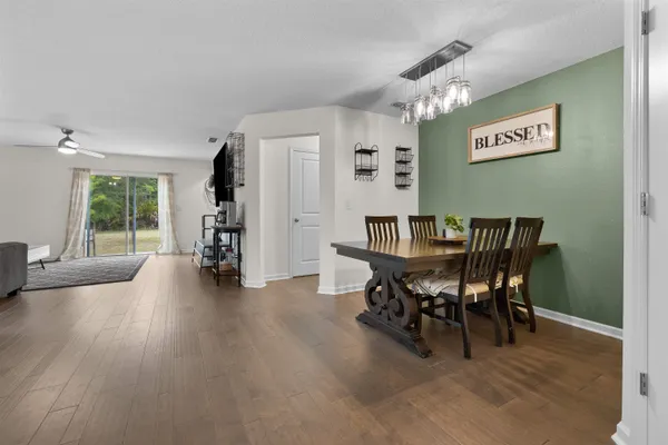 a view of a dining room with furniture and wooden floor