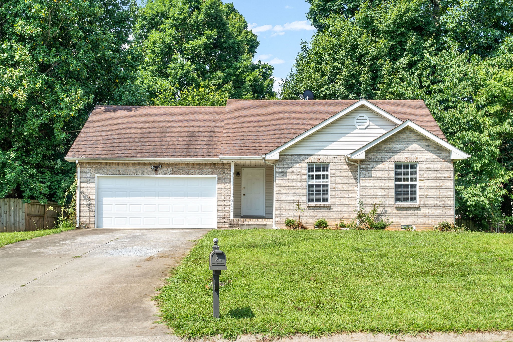 a view of a house with yard and tree s