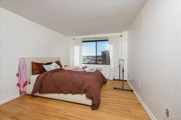 a bedroom with a bed and window