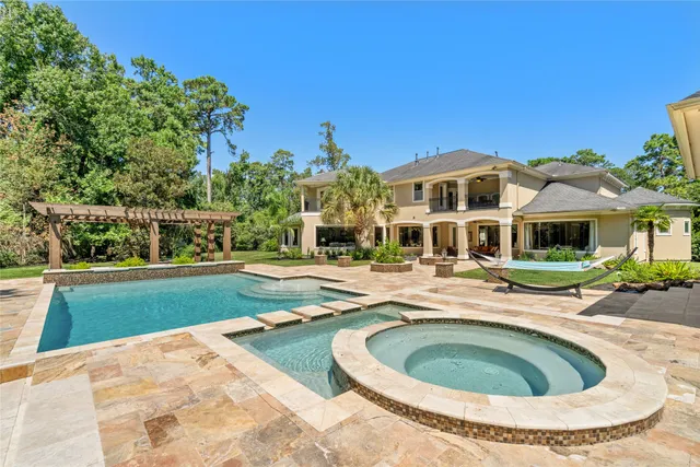 a view of a house with swimming pool and a yard