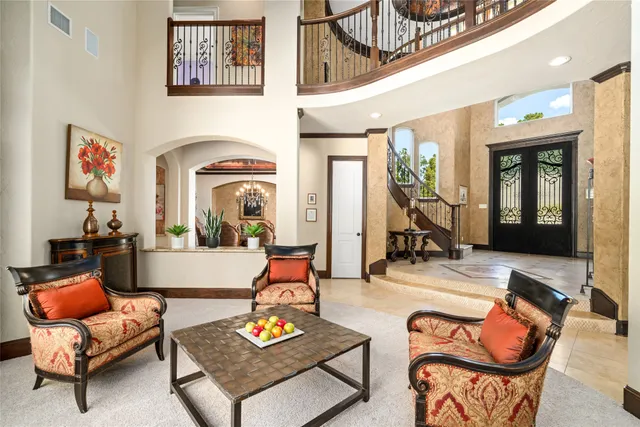 a living room with furniture a rug and a chandelier